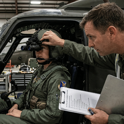 night vision goggles used by us military instructor adjusts helmet optics during aircraft readiness check