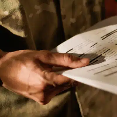 Soldier holds briefing papers in uniform reviewing flight details for army nvg operations before launch