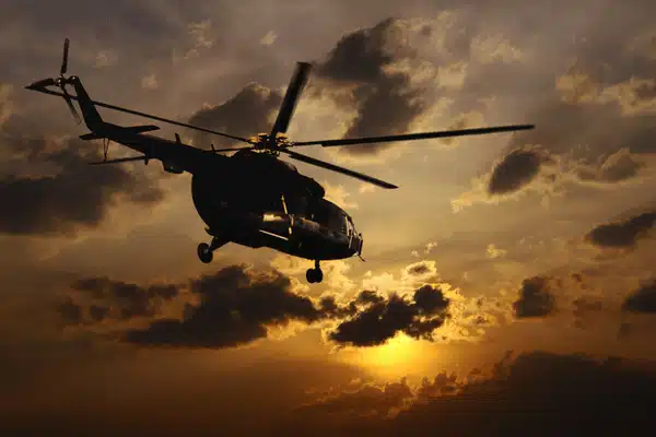 Silhouette helicopter at sunset sky, used with helicopter night vision goggles during dusk operations missions