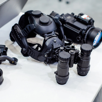 Helmet-mounted optics and binoculars displayed, representing helicopter night vision goggles equipment for aviation crews maintenance