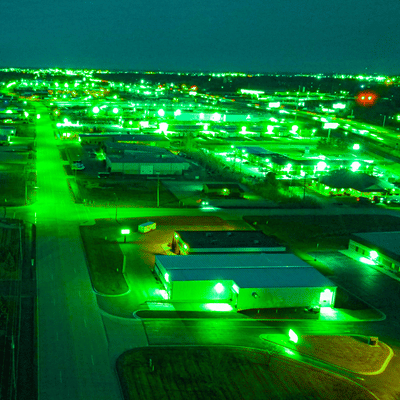 Green-tinted aerial nightscape illustrates perspective when buying night vision goggles for urban navigation at night
