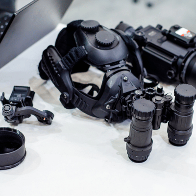 Tactical night vision goggles and accessories displayed on table for military aviation operations