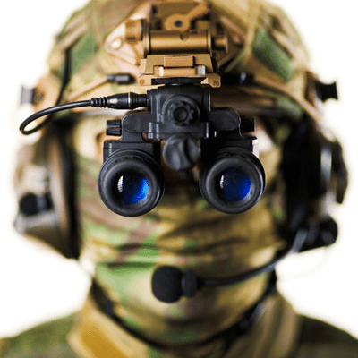 Soldier faces camera wearing binocular night-vision goggles; discusses how long do night vision goggles last