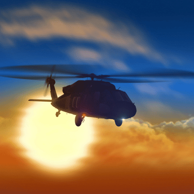 Helicopter NVG training at sunset with aircraft silhouetted against bright orange and blue sky