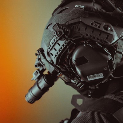 Close-up of pilot wearing tactical helmet equipped with mounted night vision device during mission
