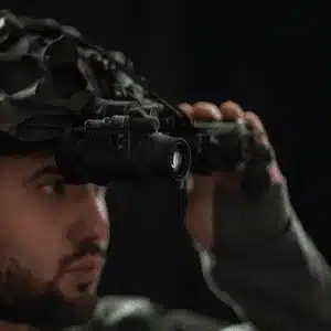 Operator lifts dual ir vision goggles to check for alignment and functionality before mission